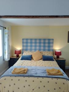 a bedroom with a large bed with two lamps at Middlehope Cottage in Westgate +42 photos