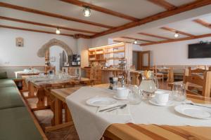 a large dining room with wooden tables and chairs at Rooms & Apartments Pr Matjon in Bled