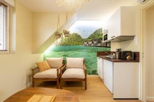 a kitchen with a wall mural of a river at Air Nomad • Bali in Valenciennes +9 photos