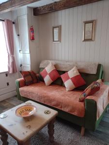 a living room with a couch and a table at Middlehope Cottage in Westgate