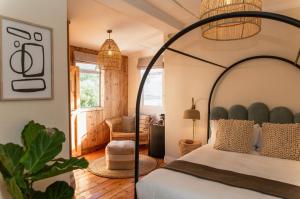 a bedroom with a bed with a wrought iron headboard at Stoep By Ideas Cartel in Kalk Bay