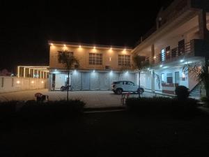 a car parked in front of a building at night at Prince Vatika in Alwar