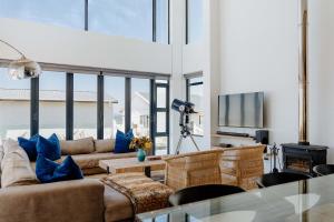 a living room with a couch and a table at Beyond The Beach in Yzerfontein