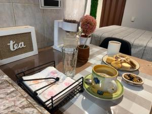 a table with a cup of coffee and a plate of food at Pausa viajera in Las Heras