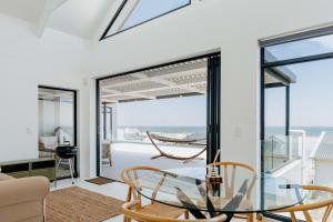 a glass table in a living room with a view of the ocean at Beyond The Beach in Yzerfontein
