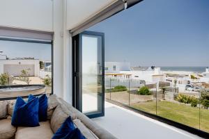 a living room with a couch and a view of the ocean at Beyond The Beach in Yzerfontein