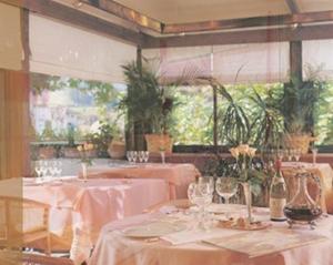 a restaurant with tables with white tablecloths and glasses at Hôtel des Pyrénées in Saint-Jean-Pied-de-Port
