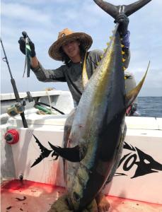 a woman holding a fish on a boat at Las Casitas de La Bahia Calechosa in Emiliano Zapata