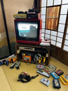 a living room with a tv and a bunch of toys at はやちねの宿ラビット in Hanamaki
