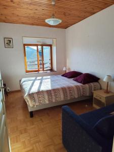 a bedroom with a large bed and a window at Dépaysement à la campagne in Saint-Martin-de-Sanzay