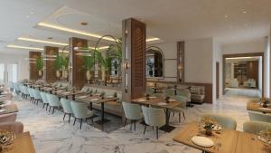 ein Restaurant mit Tischen und Stühlen in einem Raum in der Unterkunft Glory Resort in Baile Felix