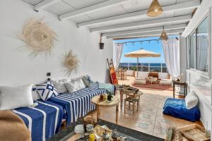 a living room with a couch and a table at Adrar Lodge - Boutique Guesthouse with Sea View in Tamraght Ouzdar