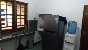 a small kitchen with a refrigerator and a sink at Pasikuda Shalom Beach Villa in Kalkudah +54 photos