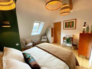 a bedroom with a large bed in a room at La source de Vaugadeland in Nazelles