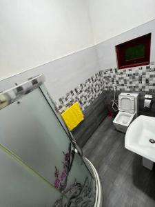 a bathroom with a sink and a toilet at BeachBay Guest House in Negombo
