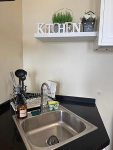a kitchen sink with a kitchen sign above it at Avida Aspira Studio, 27th Floor, Pool & Gym in Cagayan de Oro +12 photos