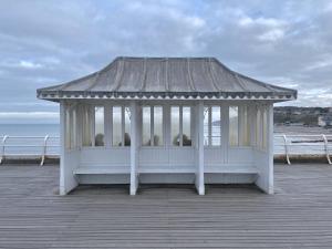 a white gazebo sitting on a pier at Shrimp Cromer in Norwich