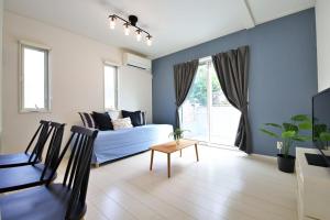 a living room with a couch and a table at Maison Haan Motobu in Motobu