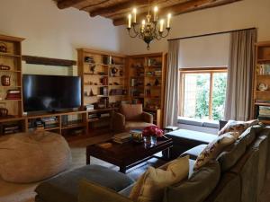 a living room filled with furniture and a flat screen tv at Navarre Residence in Stellenbosch