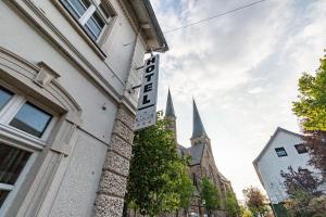 a sign on the side of a building with a church at Hotel Karger in Wadersloh