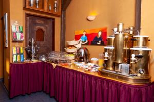 a table with a counter with food on it at Hotel Karger in Wadersloh