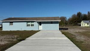 a small blue house with a sidewalk in front of it at Modern 3BR Home in secure neighborhood with Free Parking & WiFi in Riverview