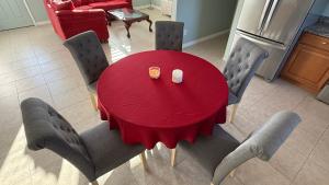 a red table with chairs andasteryasteryasteryasteryasteryasteryasteryasteryasteryastery at Modern 3BR Home in secure neighborhood with Free Parking & WiFi in Riverview