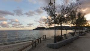 a beach with a fence next to the water at Residenza Colombi Goelba in Marina di Campo