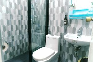 a bathroom with a toilet and a sink at Green Lodging House in Anda +31 photos