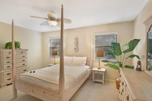 a bedroom with a bed and a ceiling fan at Villa Leo in Saint Simons Island +19 photos
