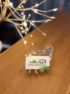 a sign for a hotel and restaurant on a table at Family Hotel EDI in Sofia