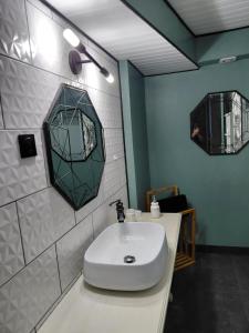 a bathroom with a sink and a mirror on the wall at La Résolue chambres d'hôtes in Millas