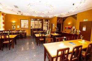 a restaurant with wooden tables and wooden chairs at Hotel Karger in Wadersloh