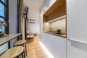 a kitchen and dining area with a counter and stools at Apartmán Daniel in Levoča