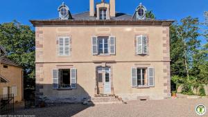 a large brick building with a tower on top at La Closerie des Anges in Saulx-de-Vesoul
