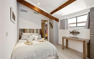 a bedroom with a large bed and a table at Duplex ForVille in Cannes