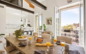 a dining room with a wooden table with food on it at Duplex ForVille in Cannes