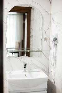 a white bathroom with a sink and a mirror at готель-ресторан Дубок in Kvasy +43 photos