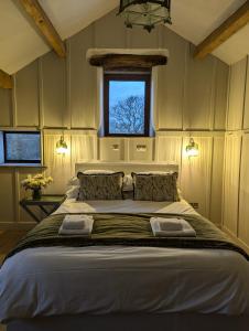 a bedroom with a large bed with a window at Laythams Holiday Lets Retreat in Slaidburn