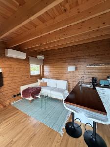 a living room with a white couch and a table at Sunset Eco Shelter 4 in Ponta do Pargo