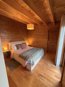 a bedroom with a bed in a wooden cabin at Sunset Eco Shelter 4 in Ponta do Pargo