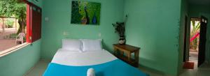 a bedroom with a bed in a blue wall at Caju Hostel in Alter do Chao +58 photos