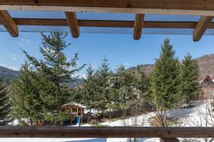 a view from the window of a cabin with trees at Casa Valasoaia in Săcele