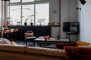 a living room with a couch and a table at BBgebouw39 - op de Rijkswerf in Den Helder
