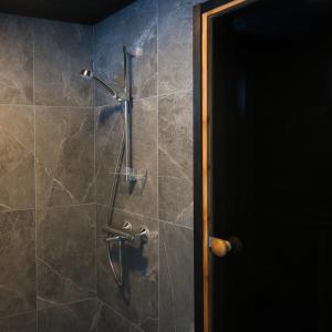 a shower in a bathroom with a glass door at Villa Rantakukka Koli, oma ranta in Kolinkylä +30 photos
