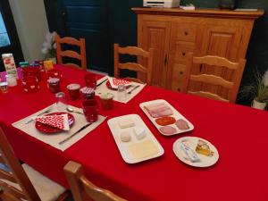 a red table with food on a red table at La Résolue chambres d'hôtes in Millas +18 photos