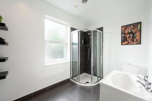a bathroom with a glass shower and a sink at Spacious Central Nottingham House in Nottingham +41 photos