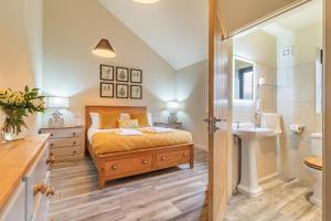 a bedroom with a bed and a sink and a toilet at 4 Bed in Heveningham oc-w29036 in Heveningham +28 photos