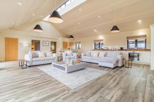 a living room with white furniture and a kitchen at 4 Bed in Heveningham oc-w29036 in Heveningham