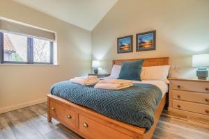 a bedroom with a bed with a dresser and a window at 4 Bed in Heveningham oc-w29036 in Heveningham